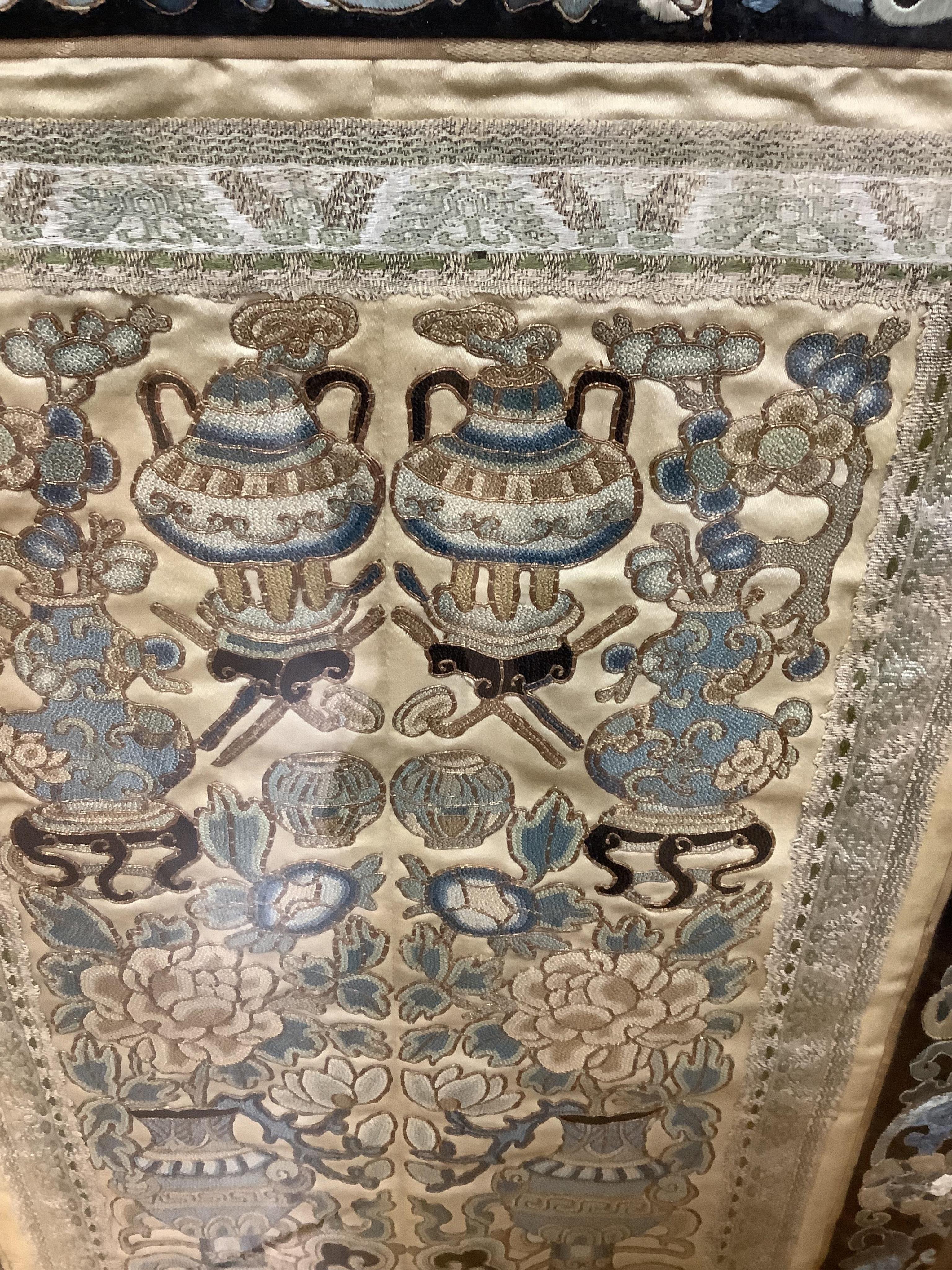 Two pairs of 19th century Chinese, Peking knot, silk embroidered sleeve bands. Worked on cream silk. Both embroidered mostly in blues and gilt thread, in flower, bird and auspicious motifs, both bordered with black silk